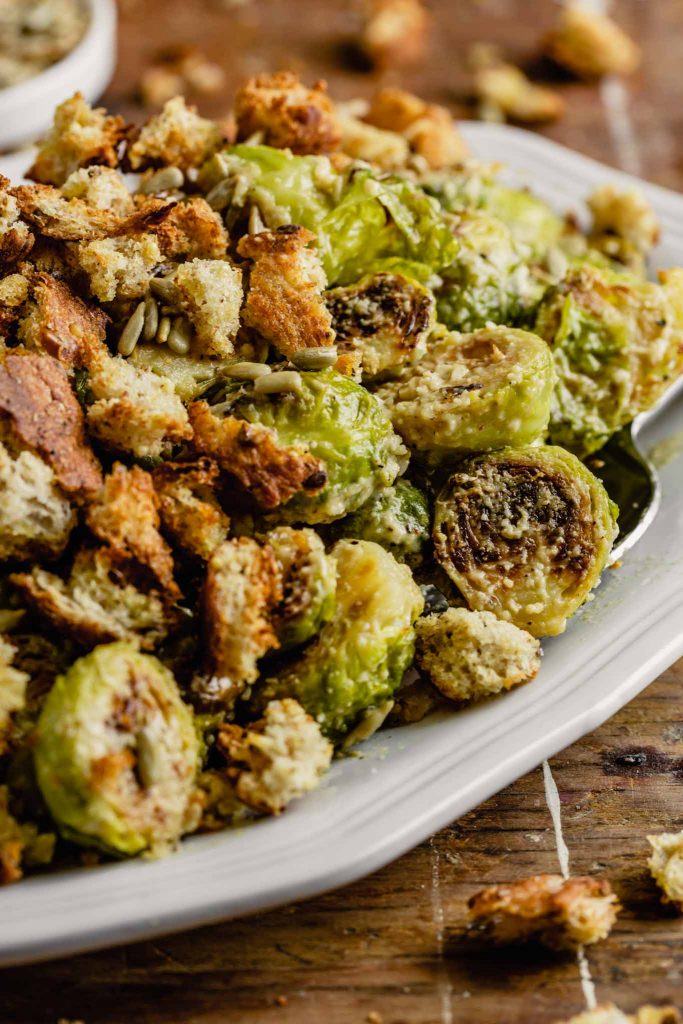 Close up image of a roasted brussel sprout tossed in caesar dressing