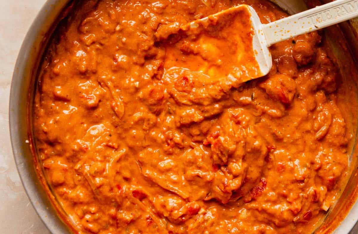 richely hued orange-colored tikka masala sauce in a skillet