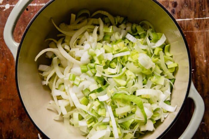 sliced onions, leeks and fennel in a large pot
