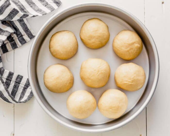 dough balls in a round cake pan
