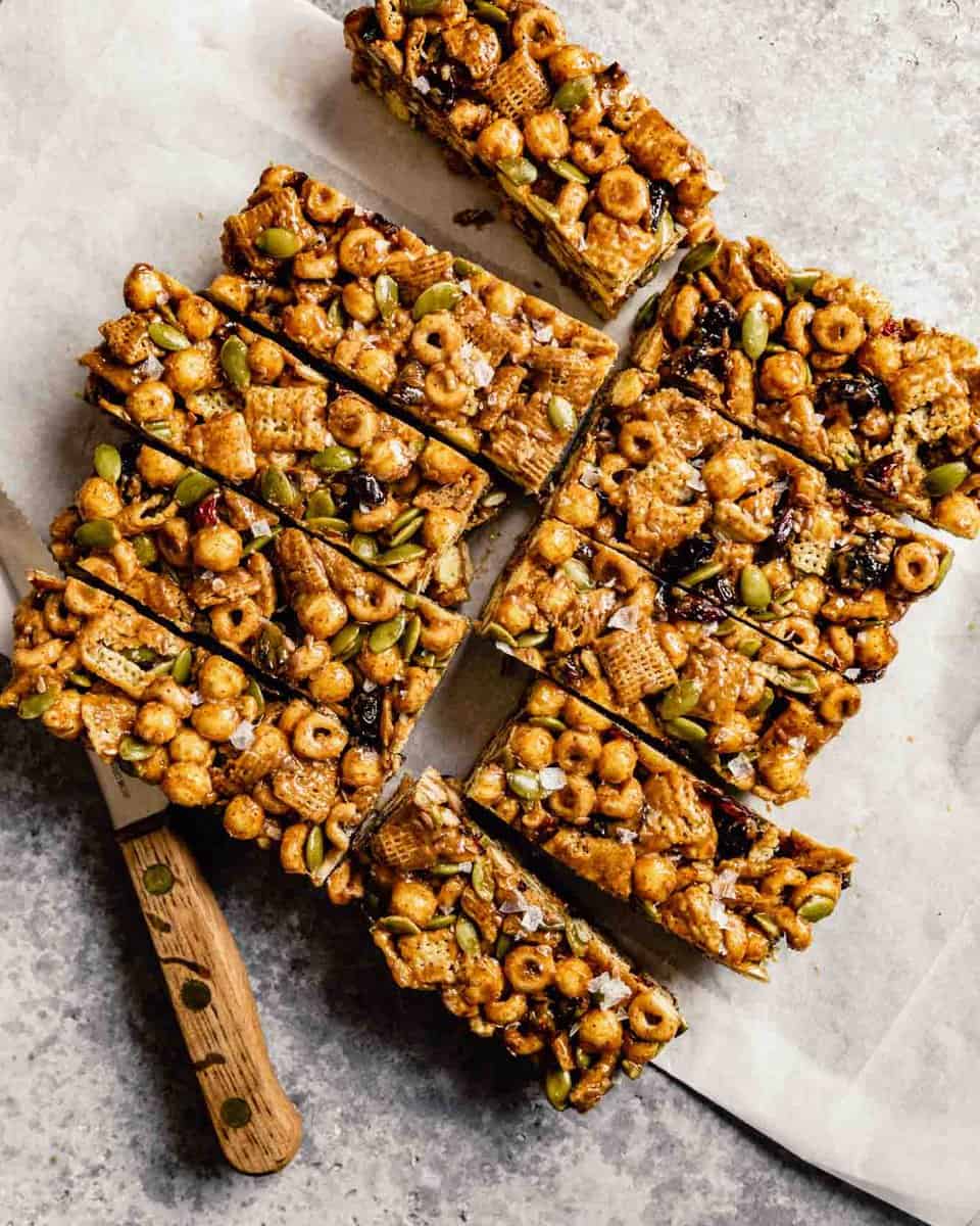 cereal bars on white parchment with a wood-handled knife