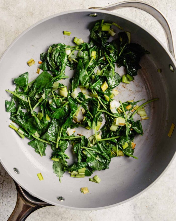 sauteed greens in a nonstick gray skillet