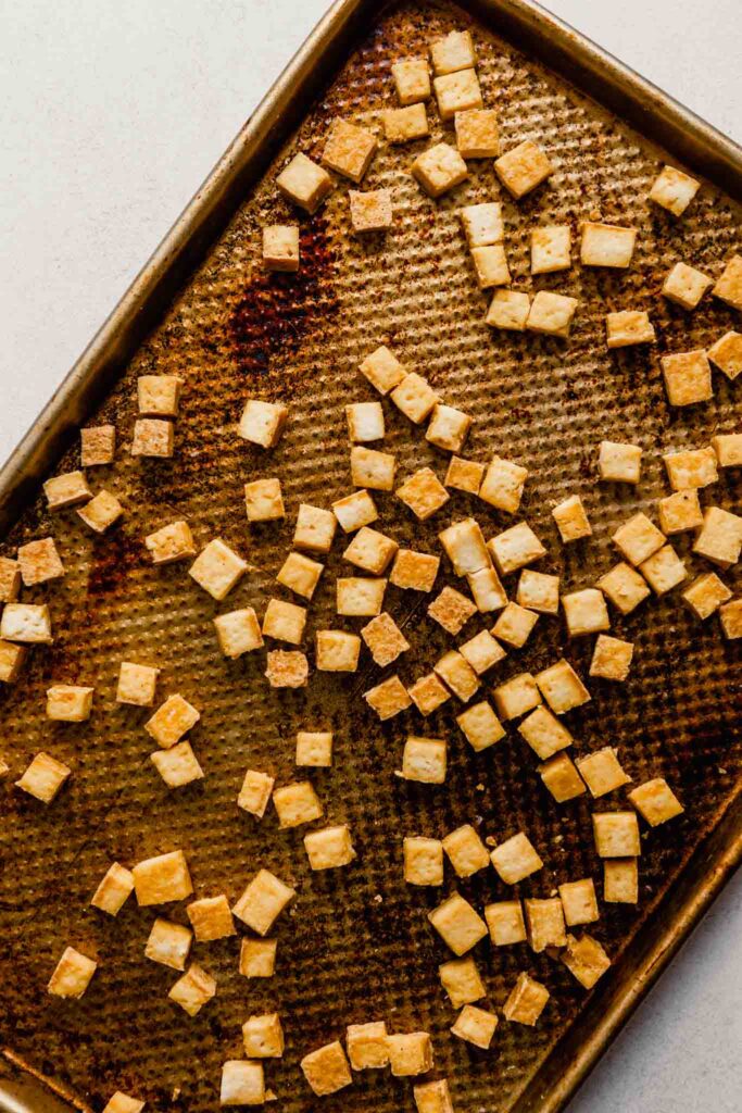 cooked cubes of tofu on a baking sheet