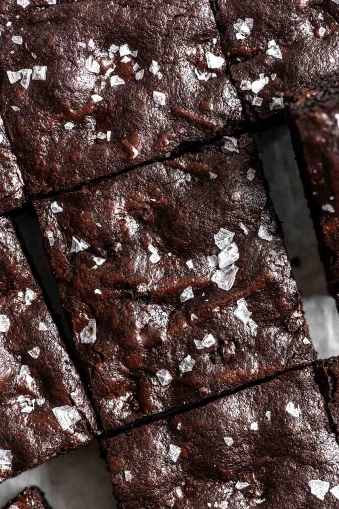 close up of brownies cut into squares with sea salt sprinkled over top