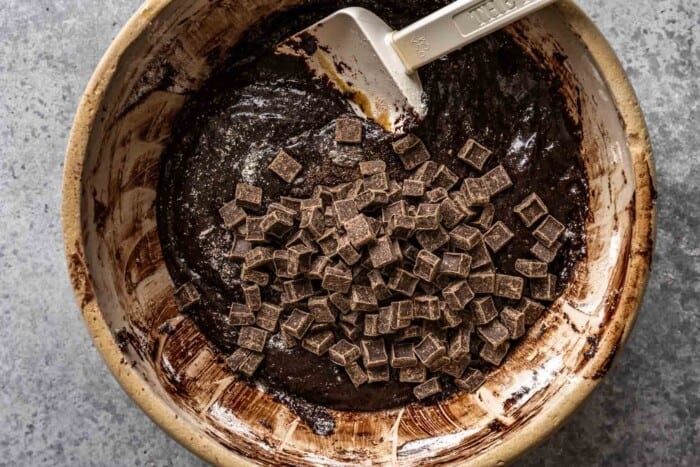 brownie batter and chocolate chunks in a mixing bowl
