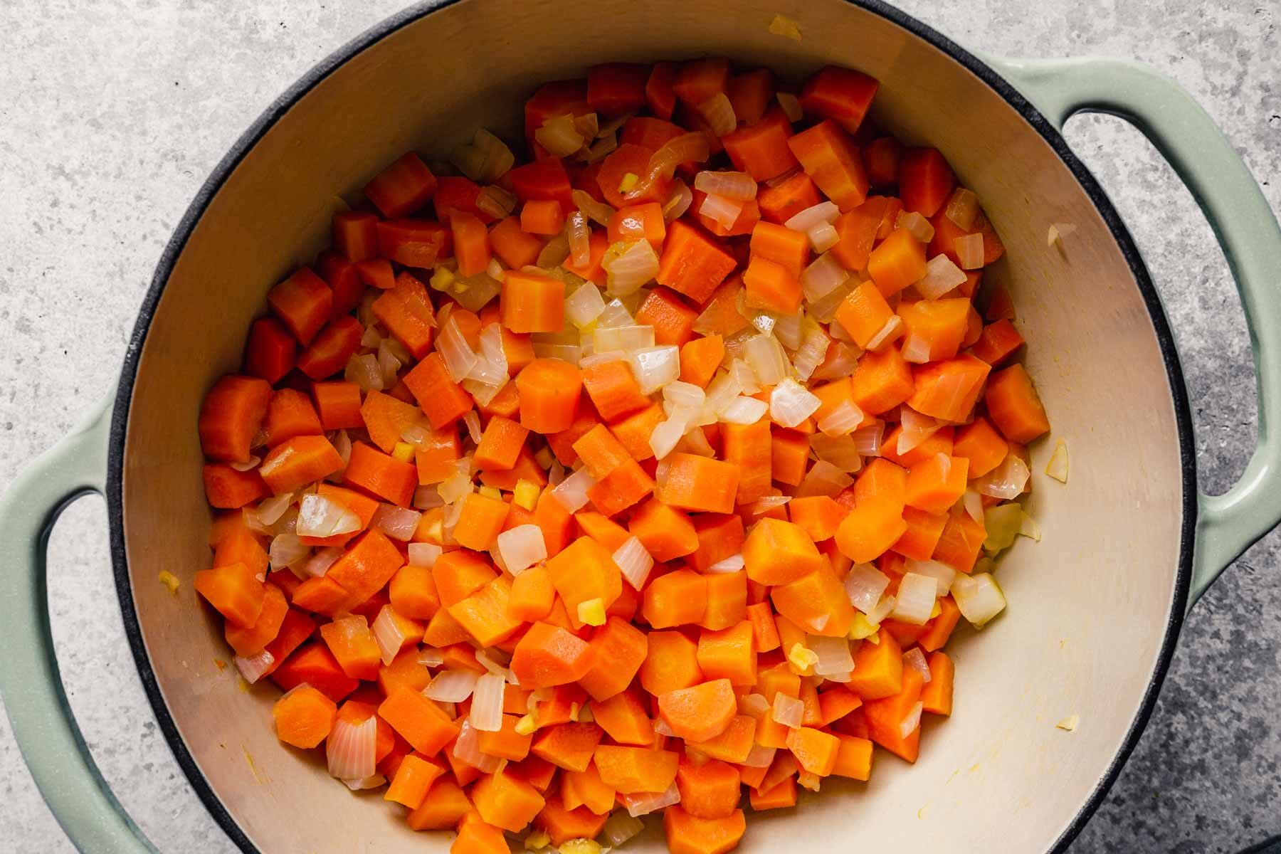 diced carrots, onion and ginger in a large dutch oven