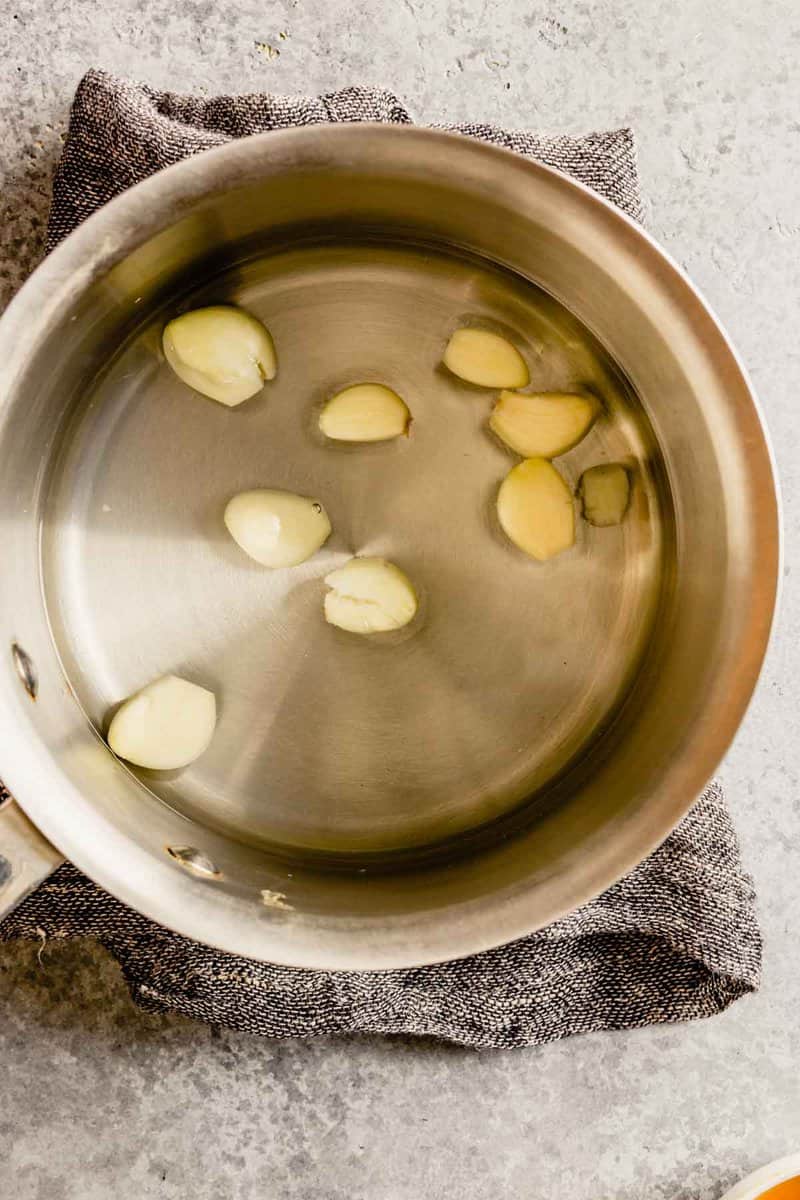 garlic cloves in a saucepan with water