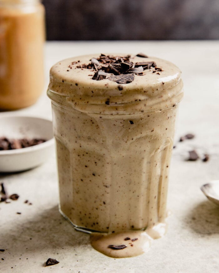 milkshake in a small glass jar with chocolate chips sprinkled on top