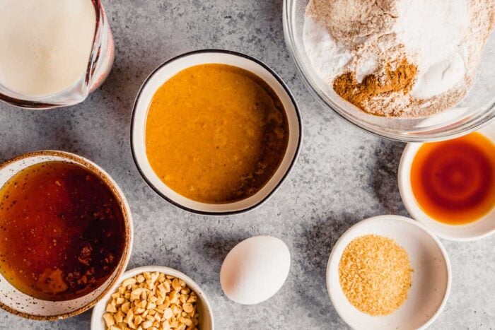 peanut butter, honey, buttermilk, flour and spices measured out in bowls on a table