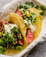 steak tacos in small sheet pans lined with parchment paper.