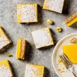 Lemon bars dusted with confectioners' sugar and set on a table