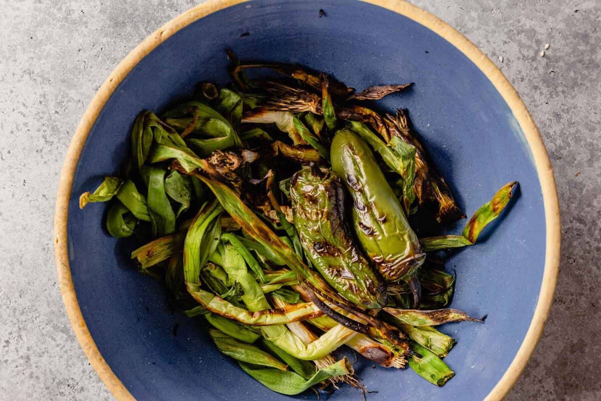 charred jalapeno and scallions in a blue bowl