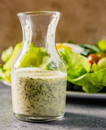 small glass vase filled with ranch dressing