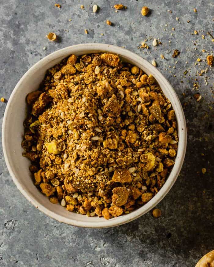 nut and spice blend in a small white bowl on a gray counter