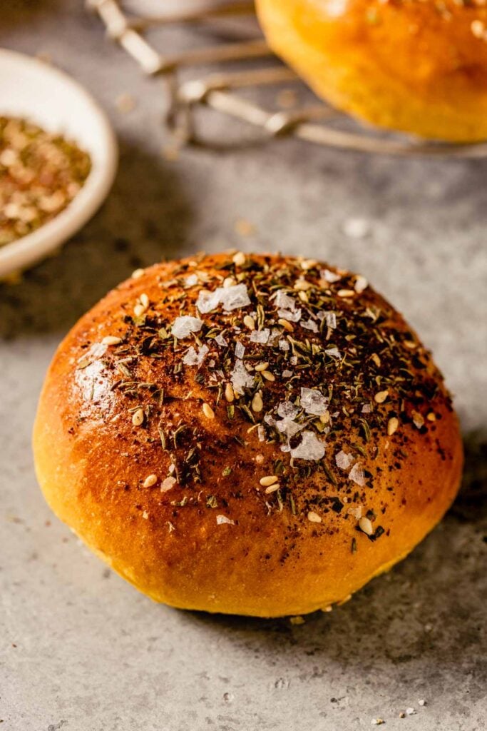 close up image of a sweet potato roll with seasoning on top