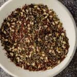 a small white bowl filled with a dried herb and sesame seed spice blend