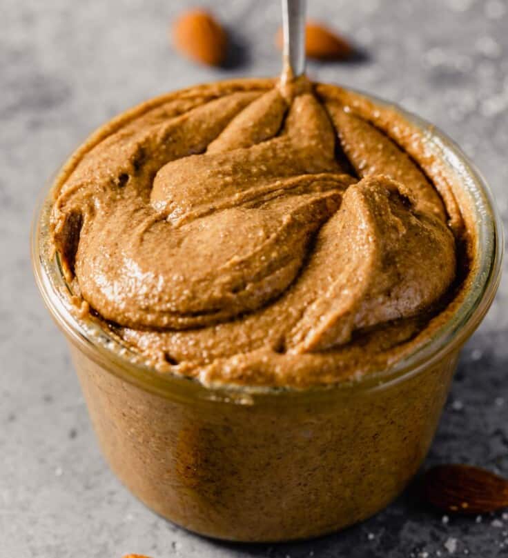 creamy almond butter in a clear glass container