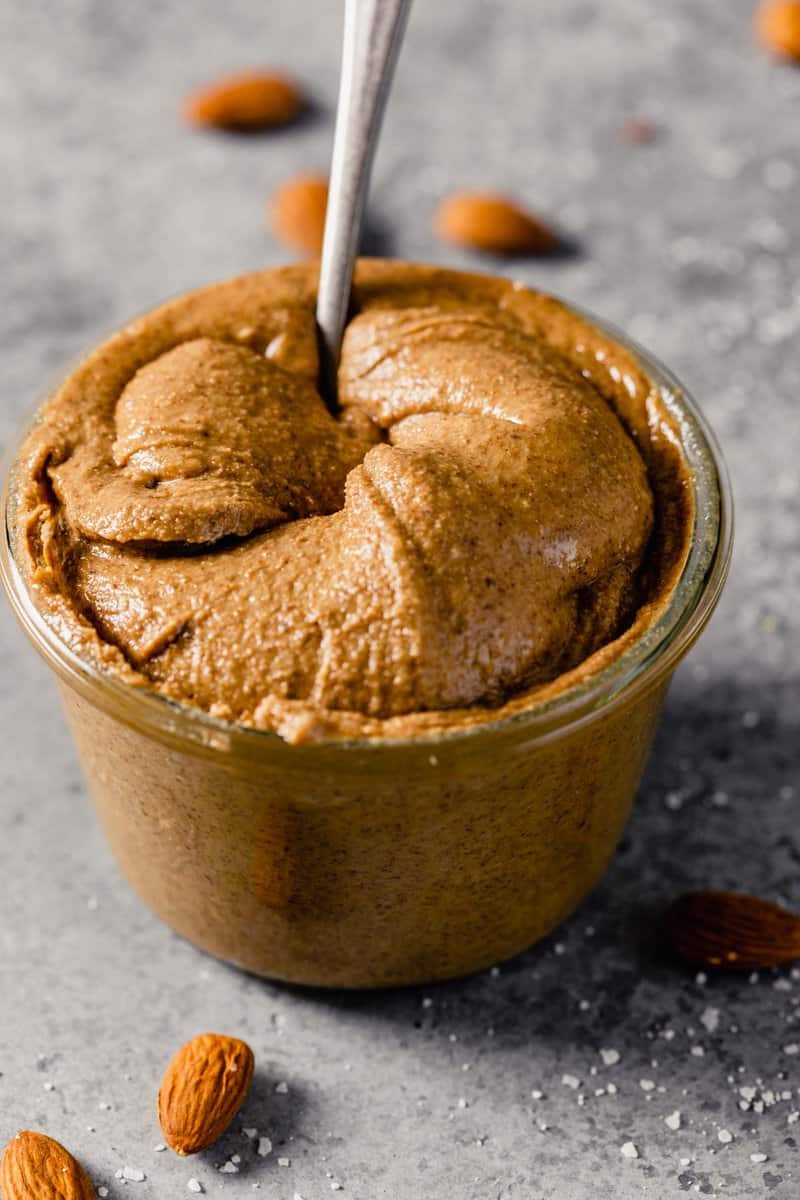 creamy almond butter in a clear glass container