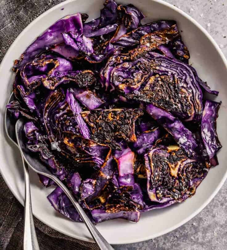 charred cabbage in a white bowl topped with salt
