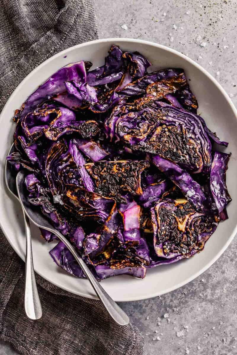 charred cabbage in a white bowl topped with salt