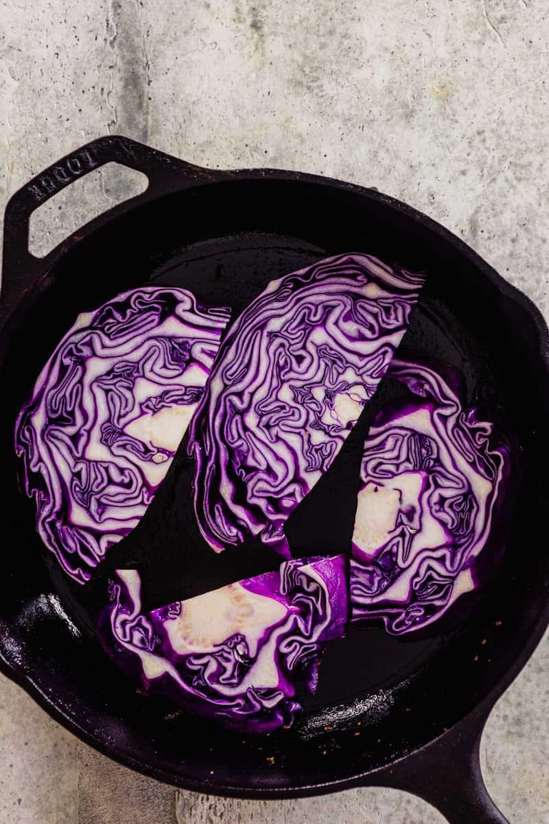 planks of cabbage in a cast-iron skillet