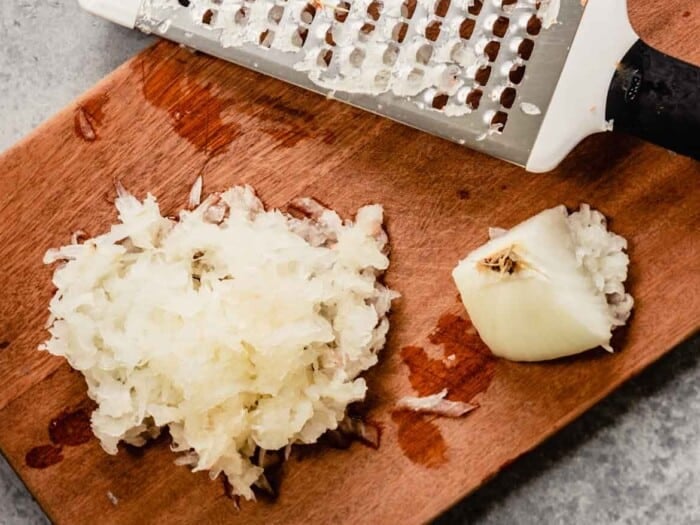 grated onion on a cutting board