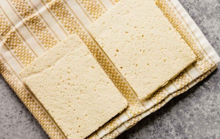 tofu slabs draining on a kitchen towel