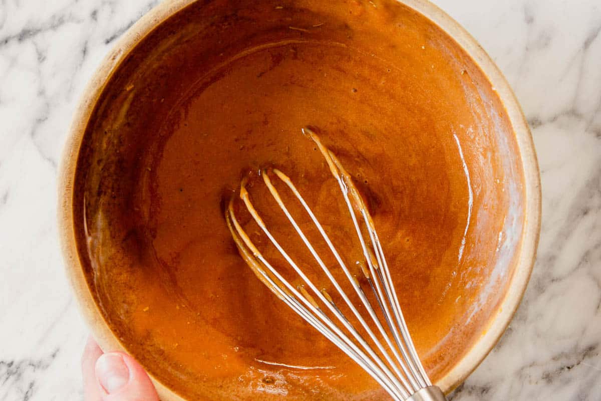sweet potato puree in a bowl with a whisk set in it