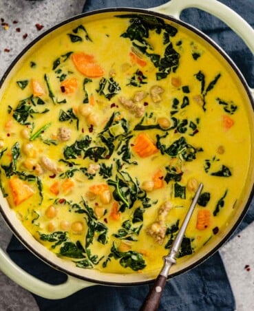 coconut curry soup with kale, chickpeas and sweet potato chunks in a large pot