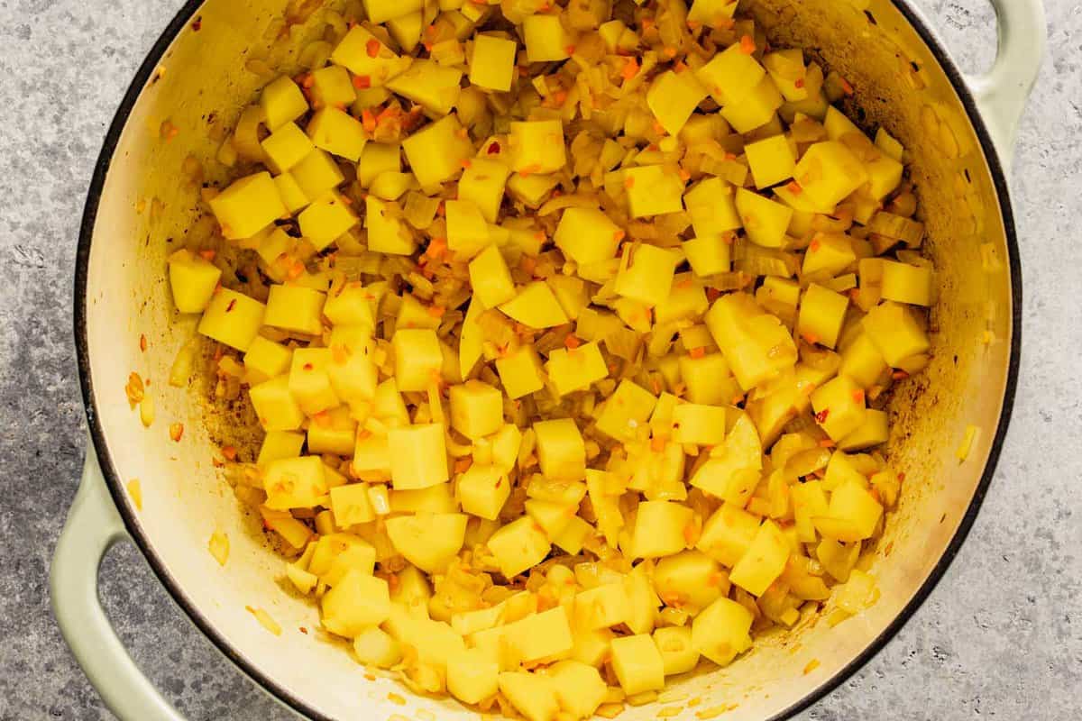 diced shallots, garlic and turmeric in a large pot with diced potato