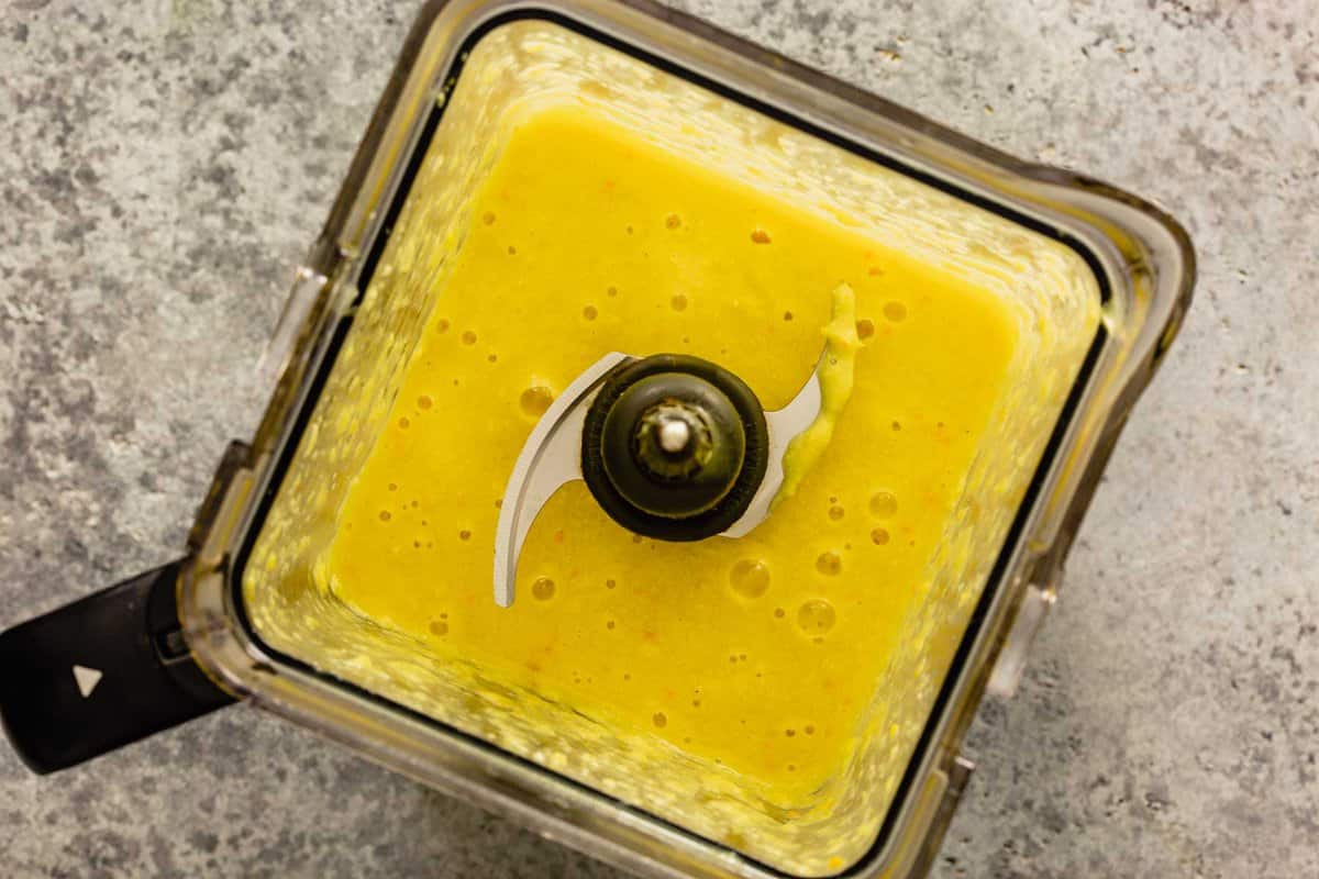 bright yellow soup in a blender