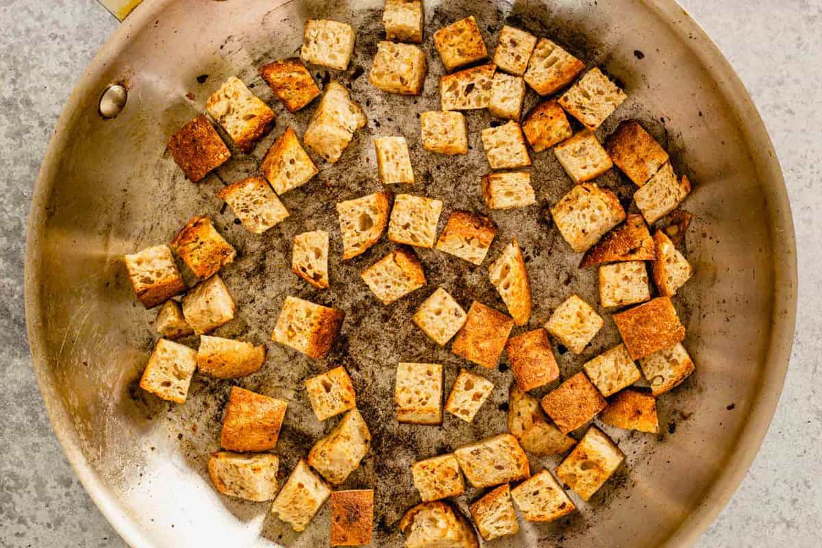 cubes of bread in a skillets