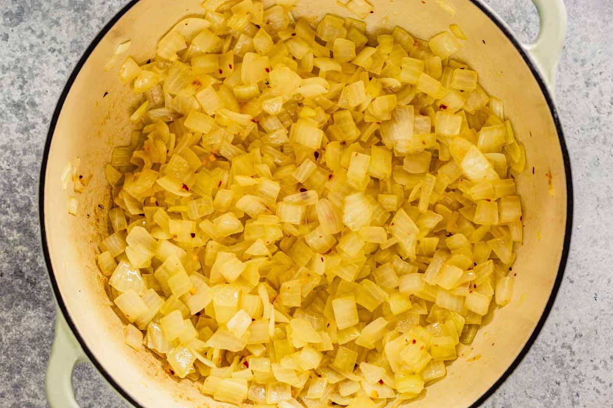 diced onions cooked in oil with red pepper flakes in a large dutch oven