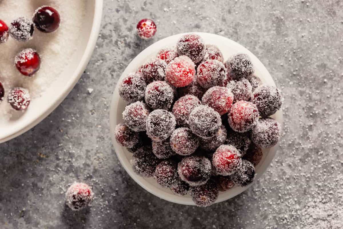 sugar-coated cranberries in a small white bowl