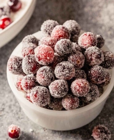 sugar-coated cranberries in a small white bowl