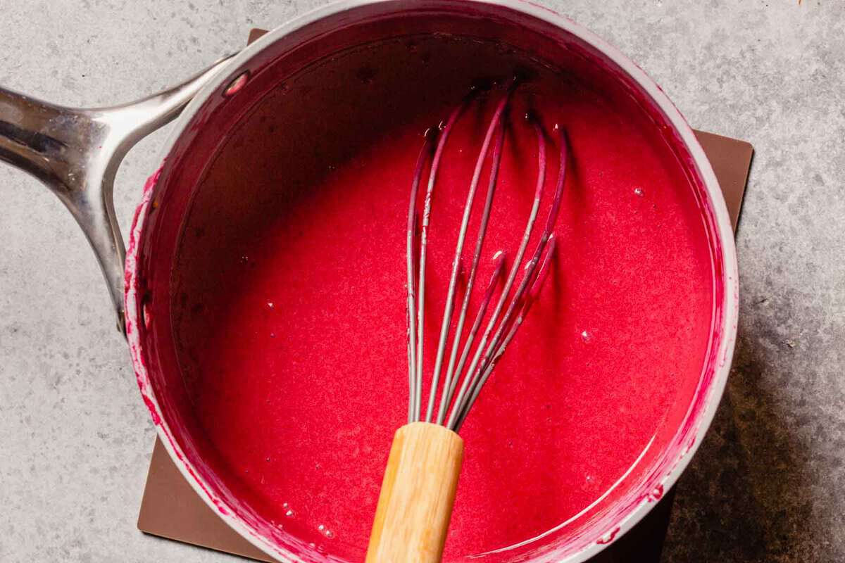 red sauce mixture in a saucepan with whisk