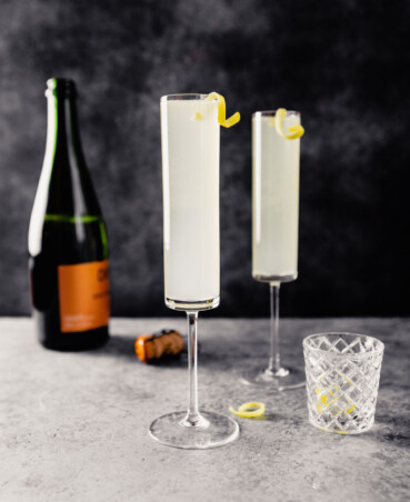 champagne flutes filled with light-yellow drink