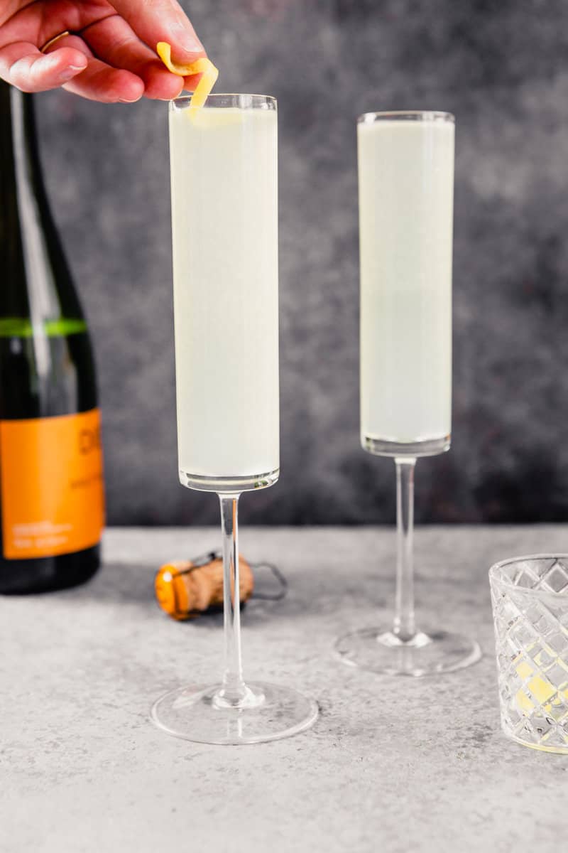 champagne flutes filled with light-yellow drink