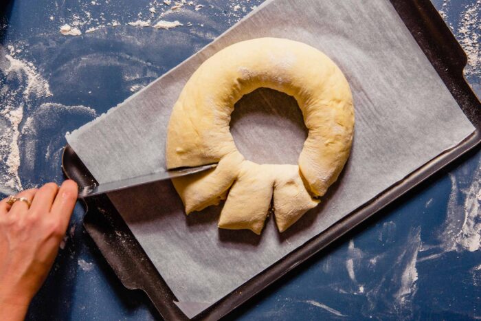 ring of dough being cut into strips