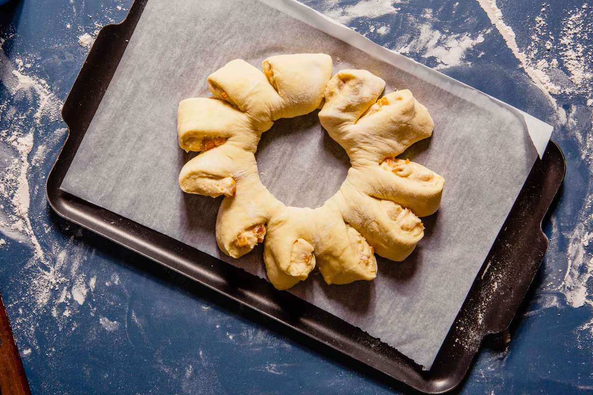dough wreath on a parchment-lined baking sheet