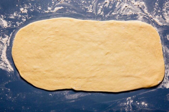 rectangle of dough on a blue table