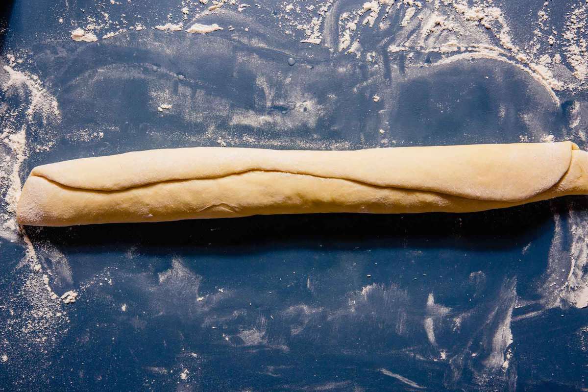 dough being rolled into a log
