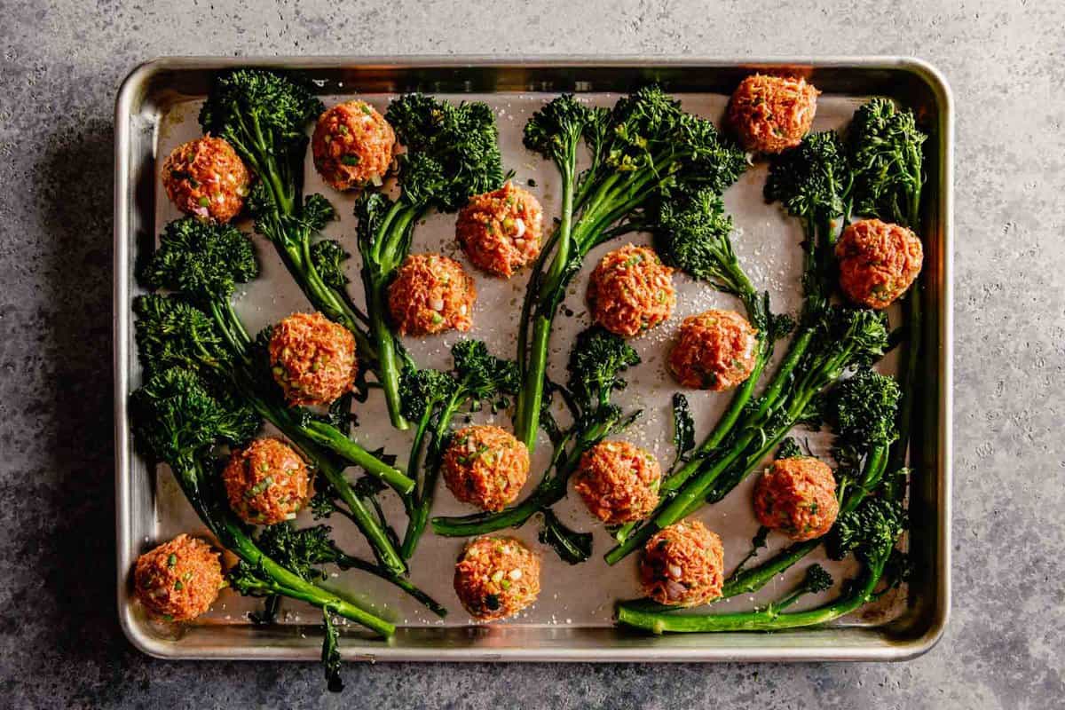 meatballs and broccolini on a sheetpan