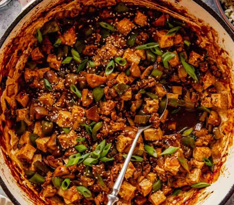 cubed tofu, ground meat and vegetables coated in a red sauce in a large pot