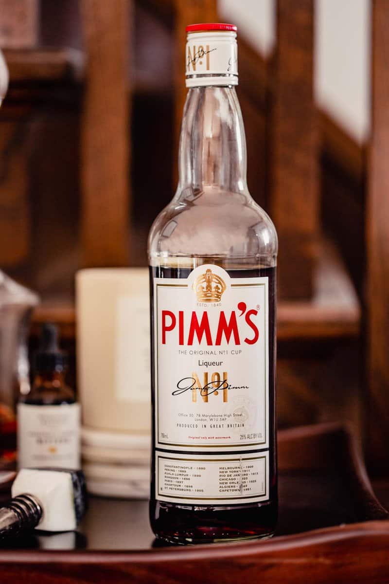 bottle of pimms no. liqueur on a wooden tray