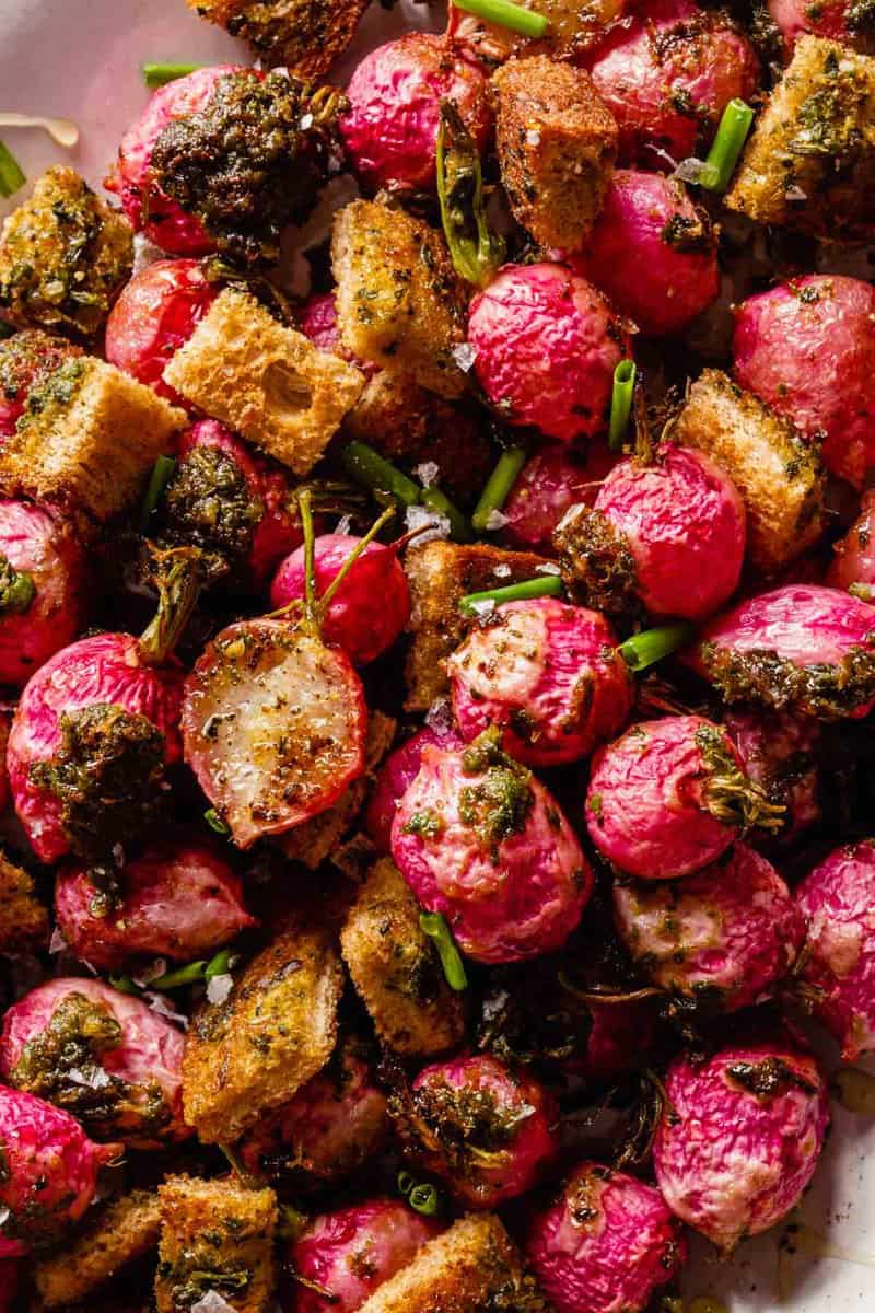 roasted radishes and croutons on a white platter