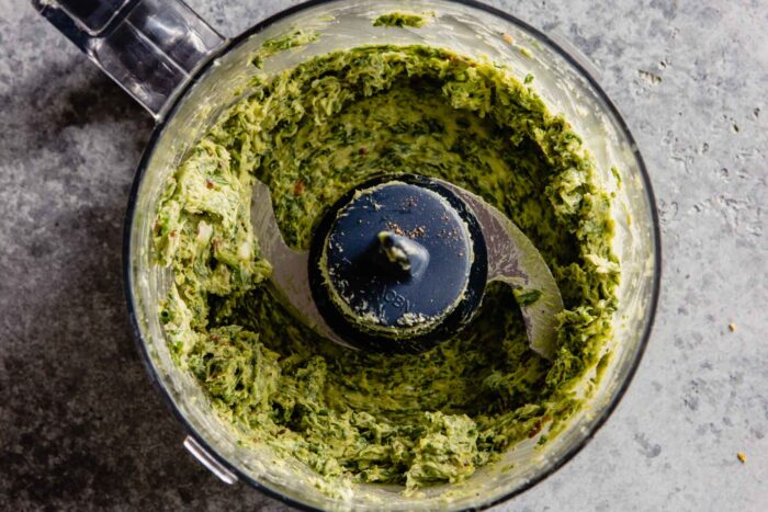 green herb butter in a food processot