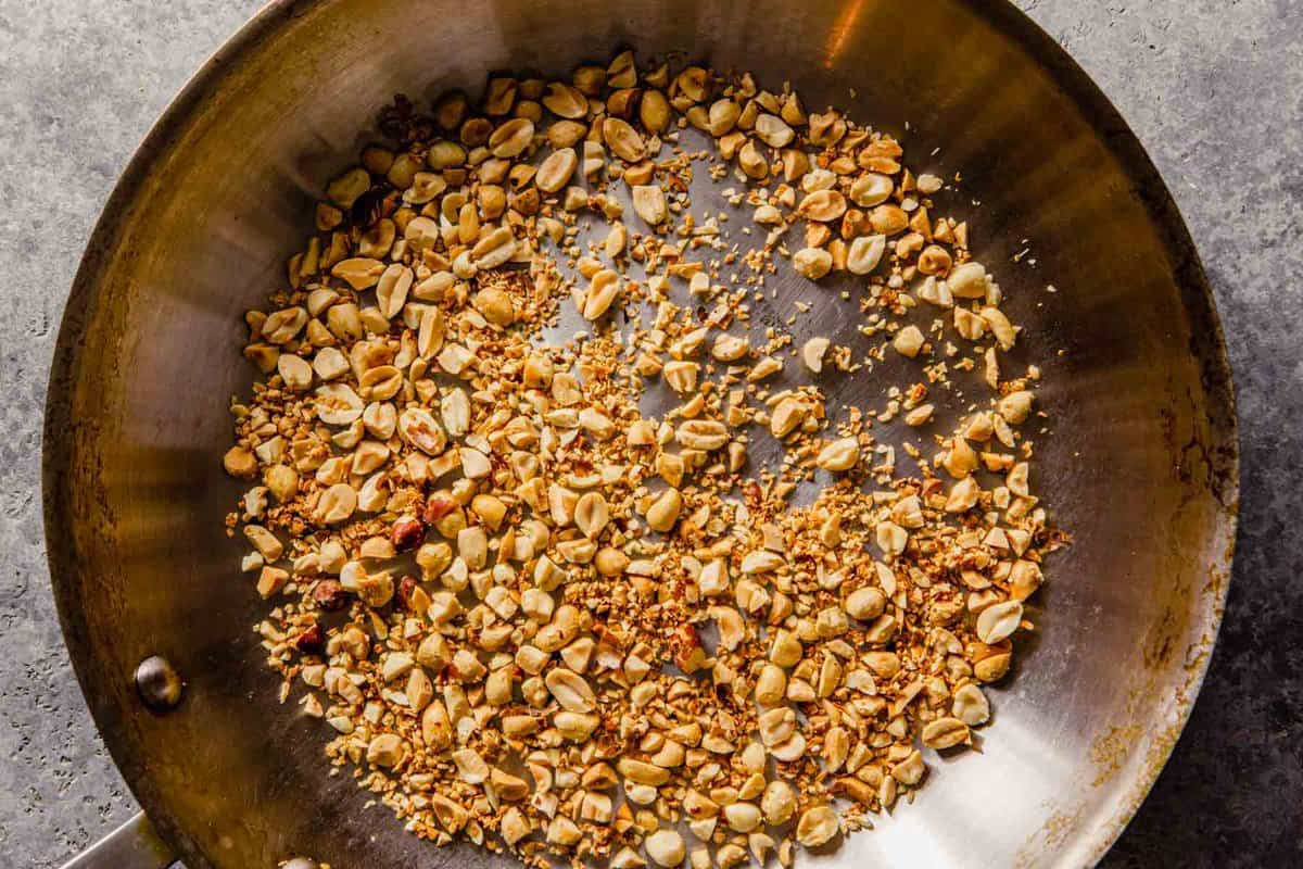 peanuts and onion flakes in a skillet