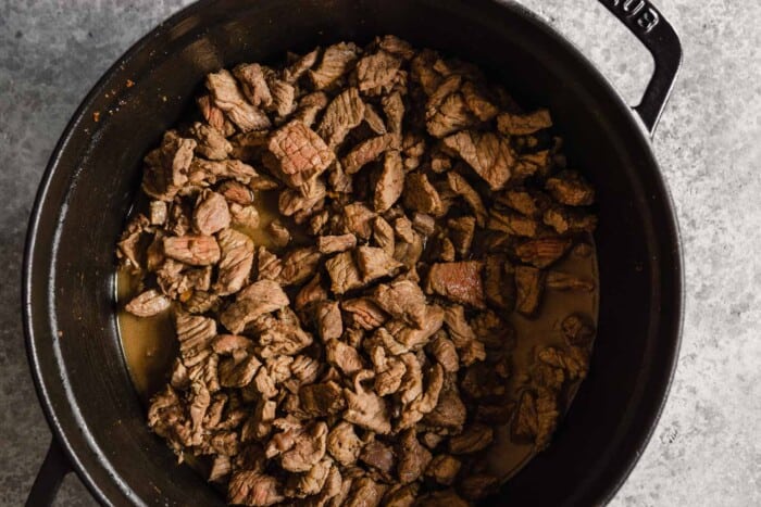 diced beef cooking in a Dutch oven