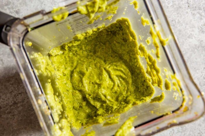 thick green sauce in a blender